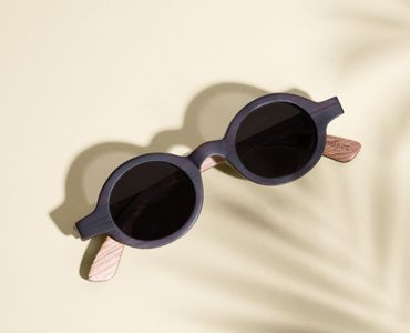 Flatlay of round wood sunglasses
