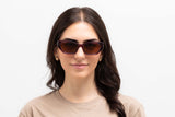 Woman wearing Riley Red Sunglasses, Red rectangular cat-eye sunglasses with brown polarized lens