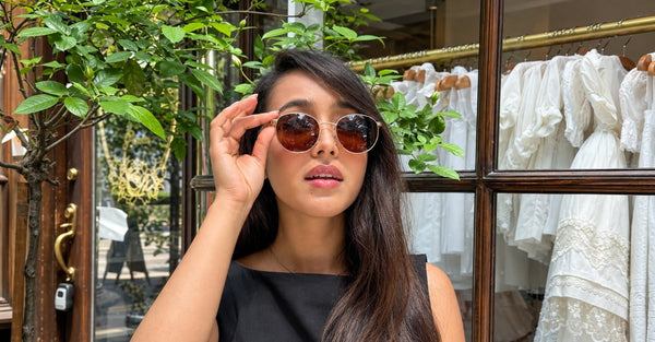 woman with round face wearing round metal sunglasses