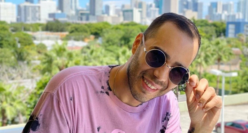 man wearing Joy Silver eyeglasses with tinted photochromic lenses outdoors