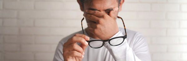 man with eye fatigue using Kraywoods anti-fatigue glasses