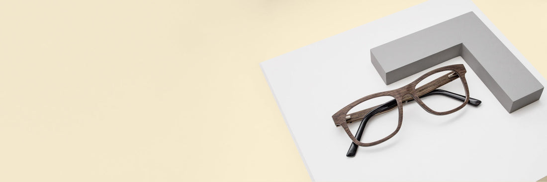 flat lay image of  Brave Brown migraine eyeglasses  on a tan background