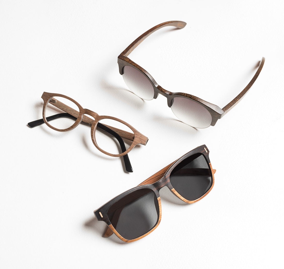 Flatlay of wood sunglasses and wood eyeglasses