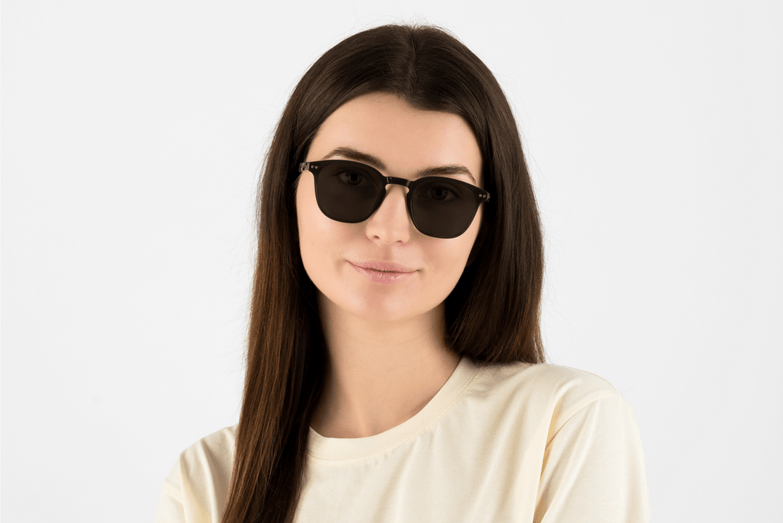 Woman wearing Dare Black, Retro Square Black glasses with tortoiseshell temples – front view