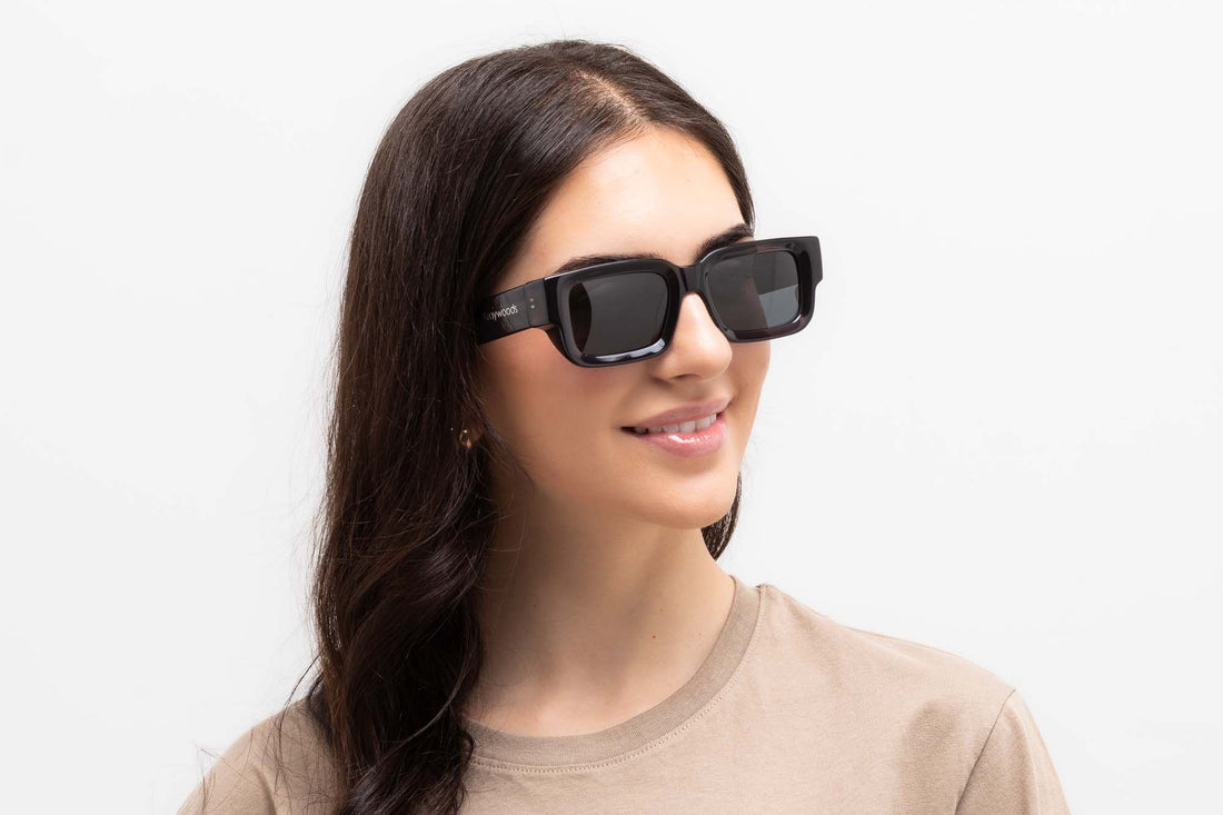 Woman wearing Nova Sunglasses, rectangle dark brown sunglasses with grey polarized lens 