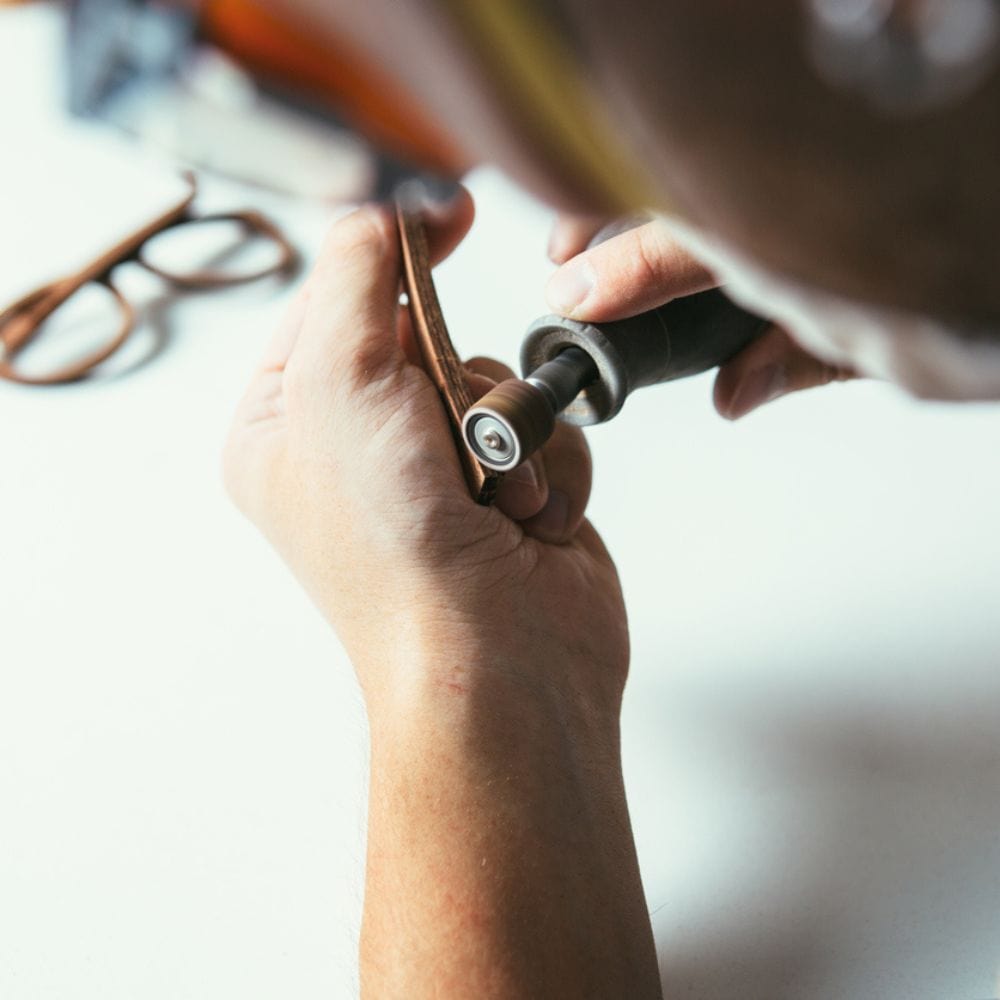 Man carving wood glasses