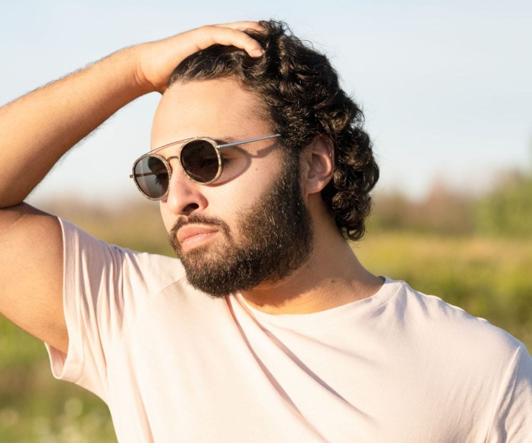 Man Wearing Kraywoods Aspen Silver, Silver Round Sunglasses made with Ebony wood and 100% UV Protection, Polarized Lenses