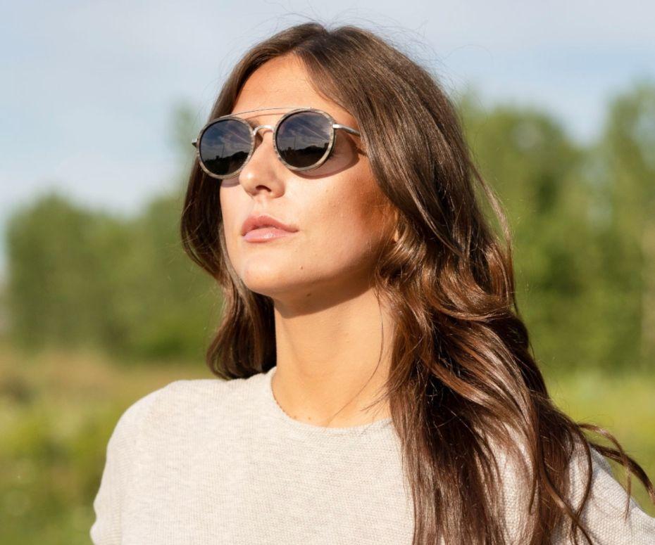 Woman wearing Kraywoods Aspen Silver, Silver Round Sunglasses made with Ebony wood and 100% UV Protection, Polarized Lenses