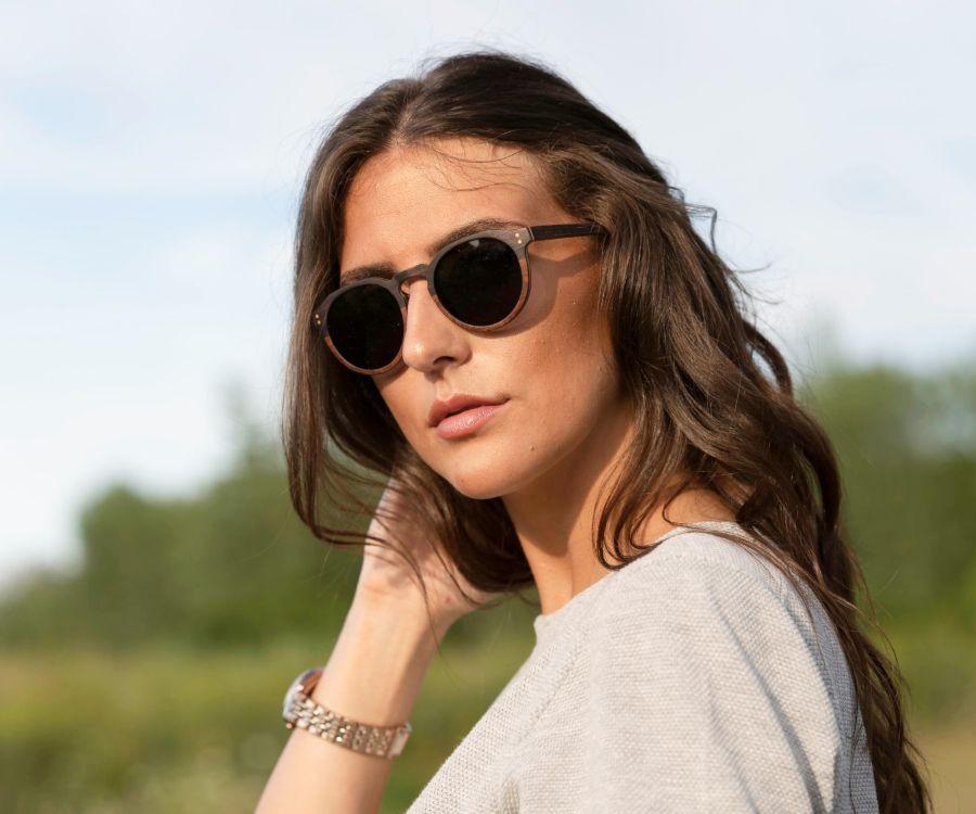 Woman wearing Kraywoods Roseland, Round Keyhole Sunglasses made from Ebony and Rose Wood with 100% UV Protection, Polarized Lenses