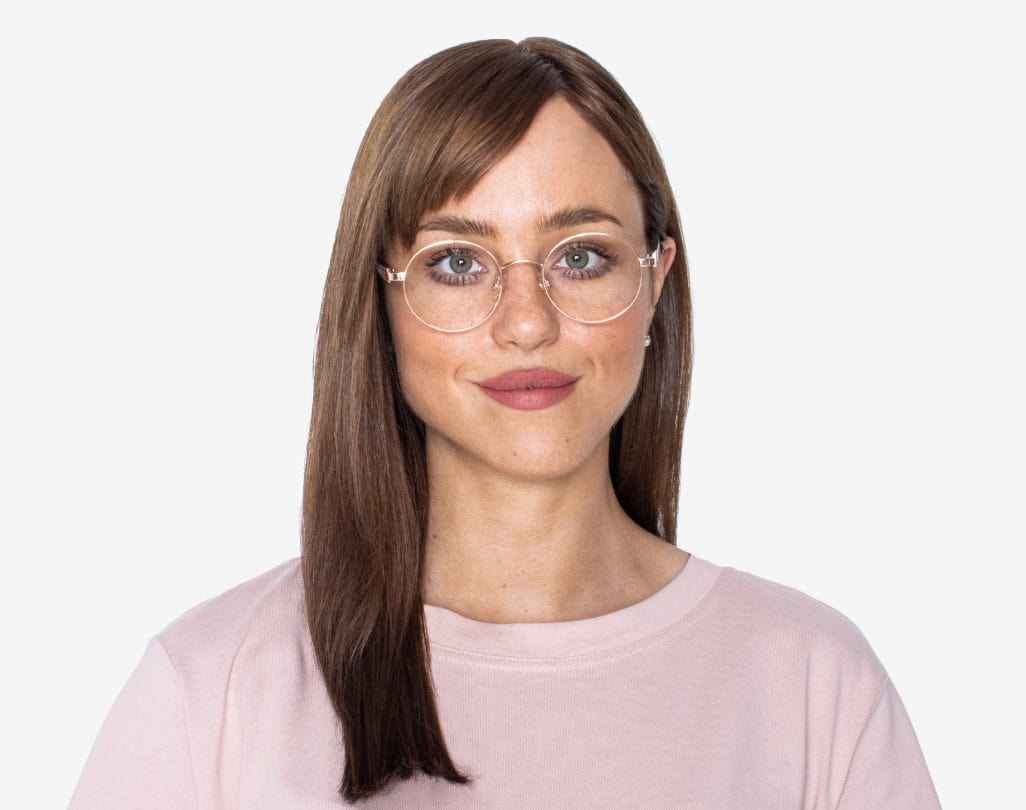 Woman wearing Joy Rose Gold - Round Eyeglasses in Rose Gold Metal