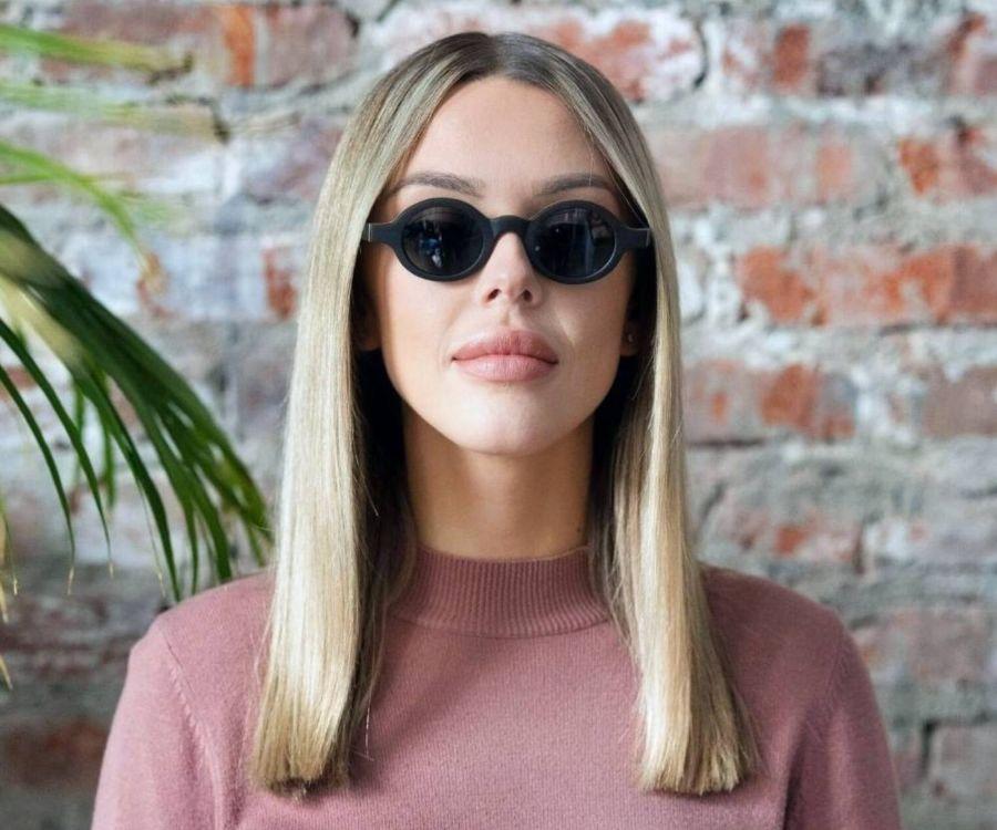 Woman wearing Kraywoods Magnolia, Small Round Sunglasses Featuring Ebony Wood Vintage Frame and 100% UV Protection, Polarized Lenses