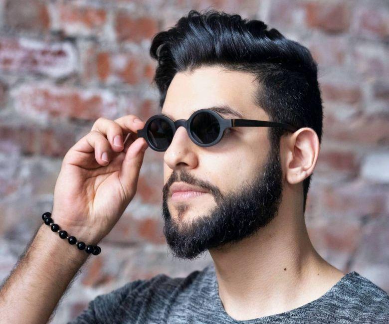 Man wearing Kraywoods Magnolia, Small Round Sunglasses Featuring Ebony Wood Vintage Frame and 100% UV Protection, Polarized Lenses