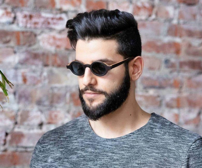 Man wearing Kraywoods Magnolia, Small Round Sunglasses Featuring Ebony Wood Vintage Frame and 100% UV Protection, Polarized Lenses