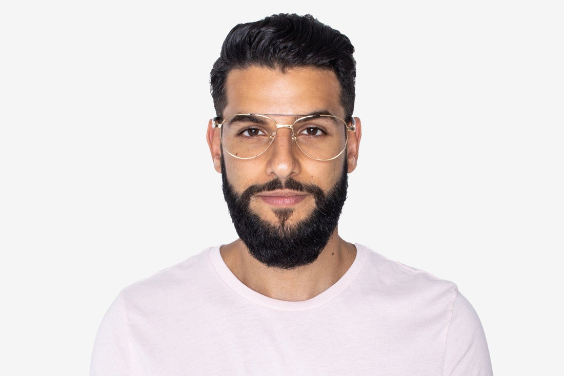 Hombre con gafas de aviador sobredimensionadas Purpose Gold