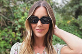 Femme portant des lunettes de soleil Mia Black, Black Octagon Geometric Sunglasses